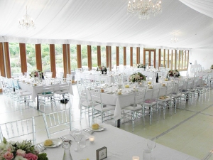 Ghost Chiavari chairs under tent setup