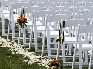 Resin folding chairs at wedding ceremony setup